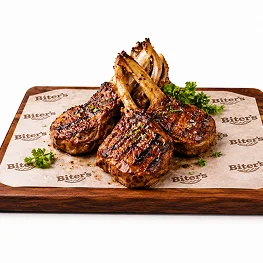 Grilled lamb chops served with salad and sauce