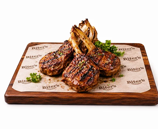 Grilled lamb chops served with salad and sauce
