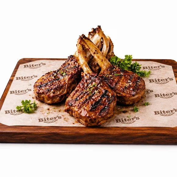 Grilled lamb chops served with salad and sauce